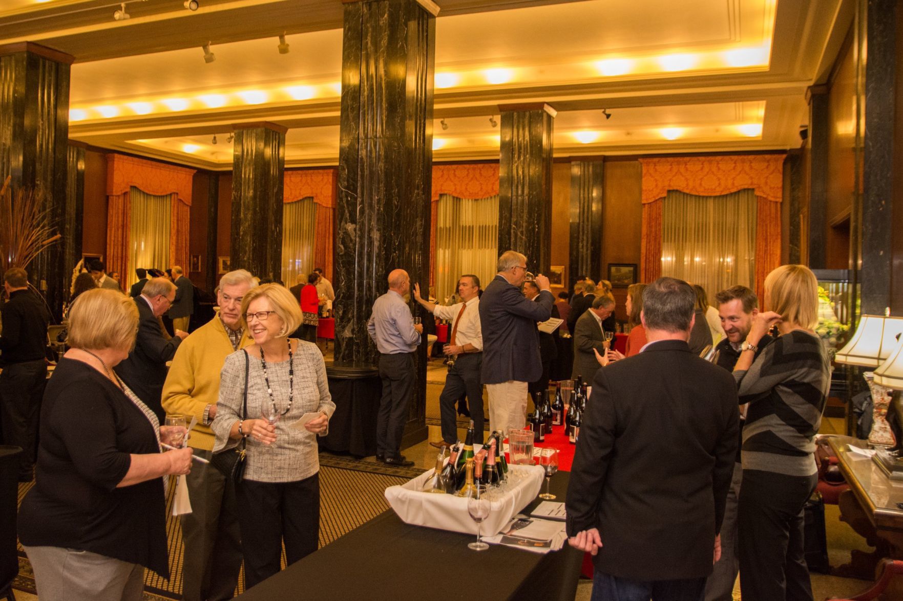Attendees mingle and chat between vendor tables